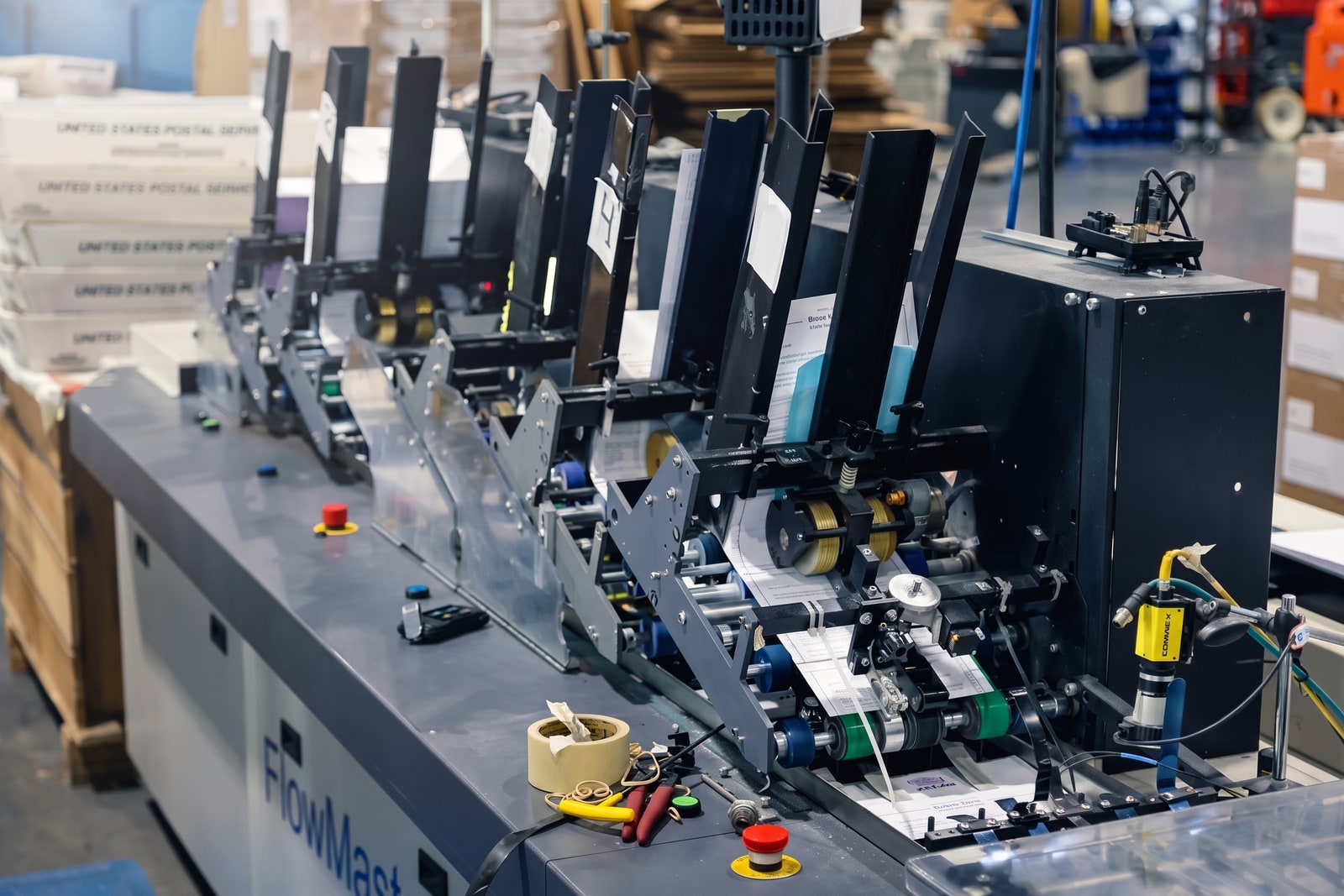 FlowMaster inserting line running letters with USPS trays staged beside it
